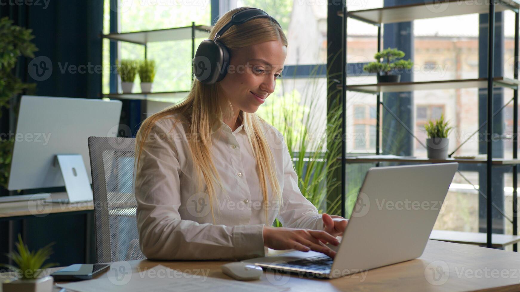 Caucasian woman working with business project online typing email on laptop at office smiling happy female businesswoman manager browsing internet computer e-commerce work studying cheerful girl smile photo