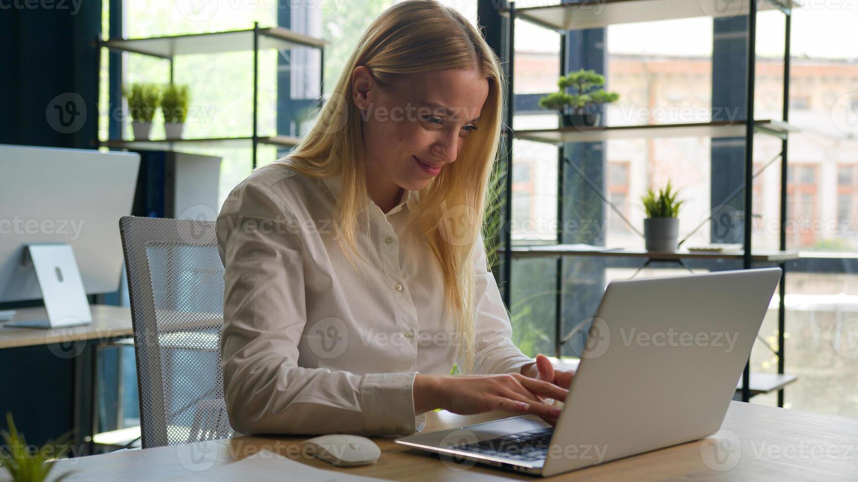 Caucasian woman working with business project online typing email on laptop at office smiling happy female businesswoman manager browsing internet computer e-commerce work studying cheerful girl smile photo
