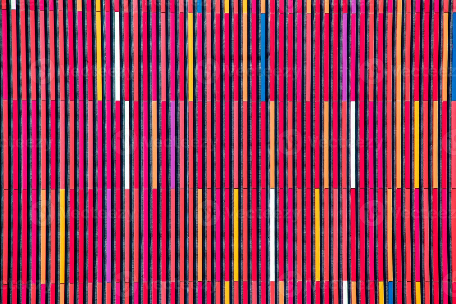 Geometrical background in colorful multi-colored stripes in red tones. Abstract background or texture. photo