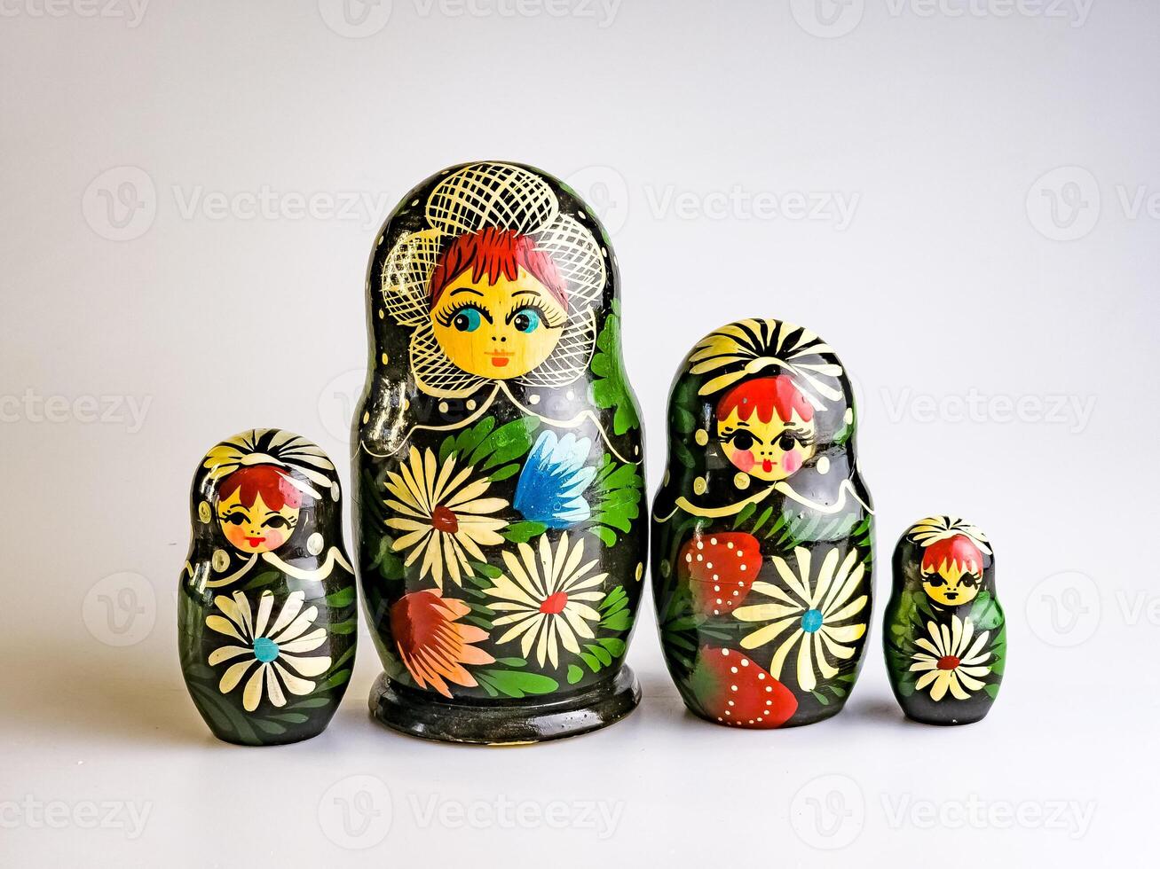 Four Matryoshka dolls of different sizes, Russian wooden doll on a white background. Painted with flowers photo