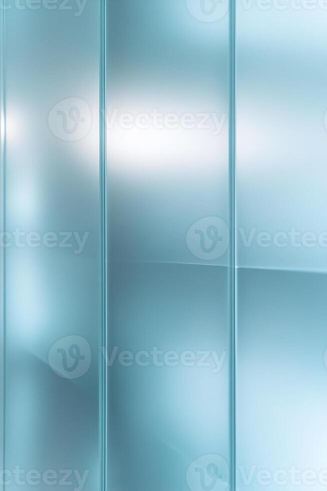Frosted glass panels with a light blue tint fill the space with soft light, casting intricate patterns onto the smooth surface. Ample negative space enhances the serene, sophisticated vibe photo