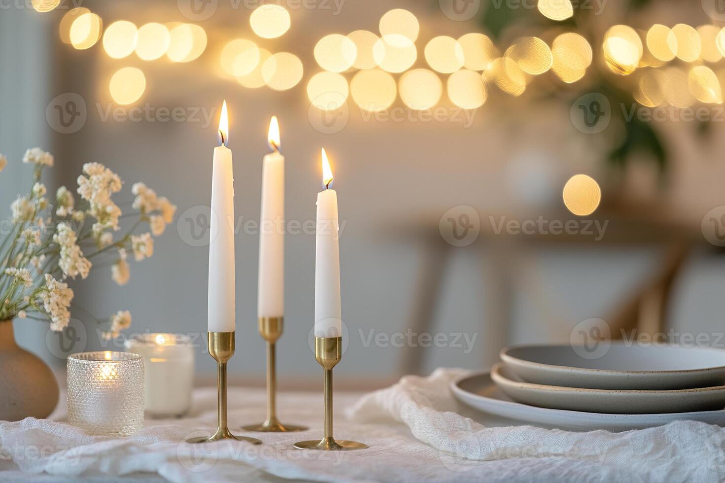The table is elegantly adorned with tall white candles in brass holders, muted ceramic plates, and a soft linen runner, creating an intimate and inviting atmosphere for Easter celebrations photo
