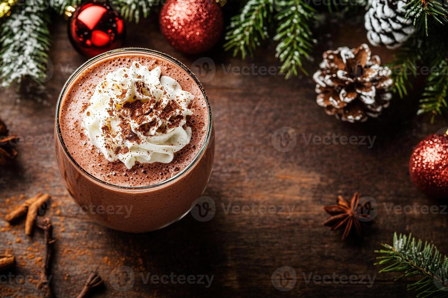 Indulge in a luxurious chocolate smoothie adorned with whipped cream, cocoa powder, and holiday spices. It rests invitingly on a dark wooden table, surrounded by winter decor photo
