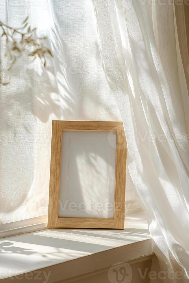 A light oak picture frame rests on a windowsill, illuminated by soft natural light streaming through sheer white curtains, evoking a peaceful, airy ambiance perfect for displaying memories photo