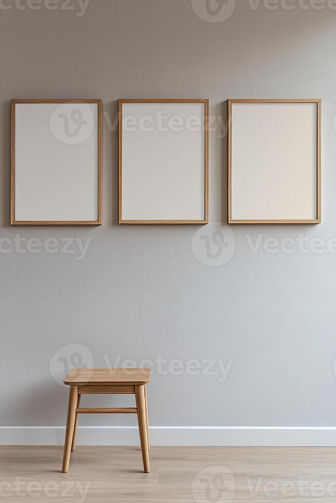 Three empty frames of varying sizes create a minimalist gallery wall against a light gray background. The natural wood and white finishes highlight modern decor, perfect for personalization photo