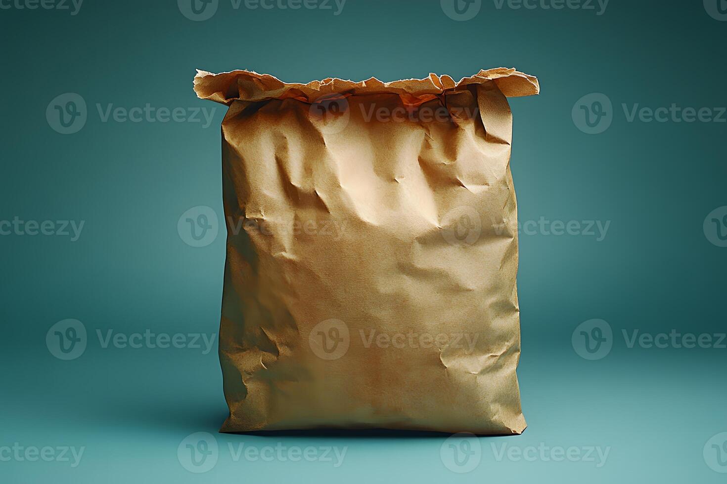 Crumpled Paper Bag Against Teal Background for Packaging Design Concepts photo