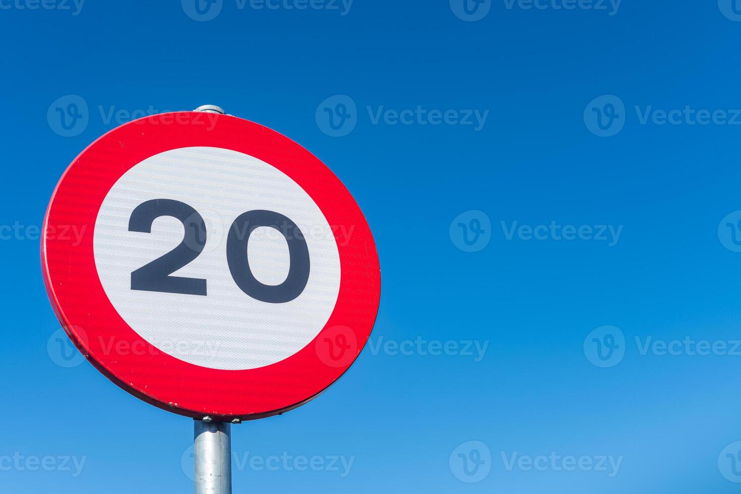 twenty kilometers per hour speed limit sign with blue sky background, background traffic concept photo