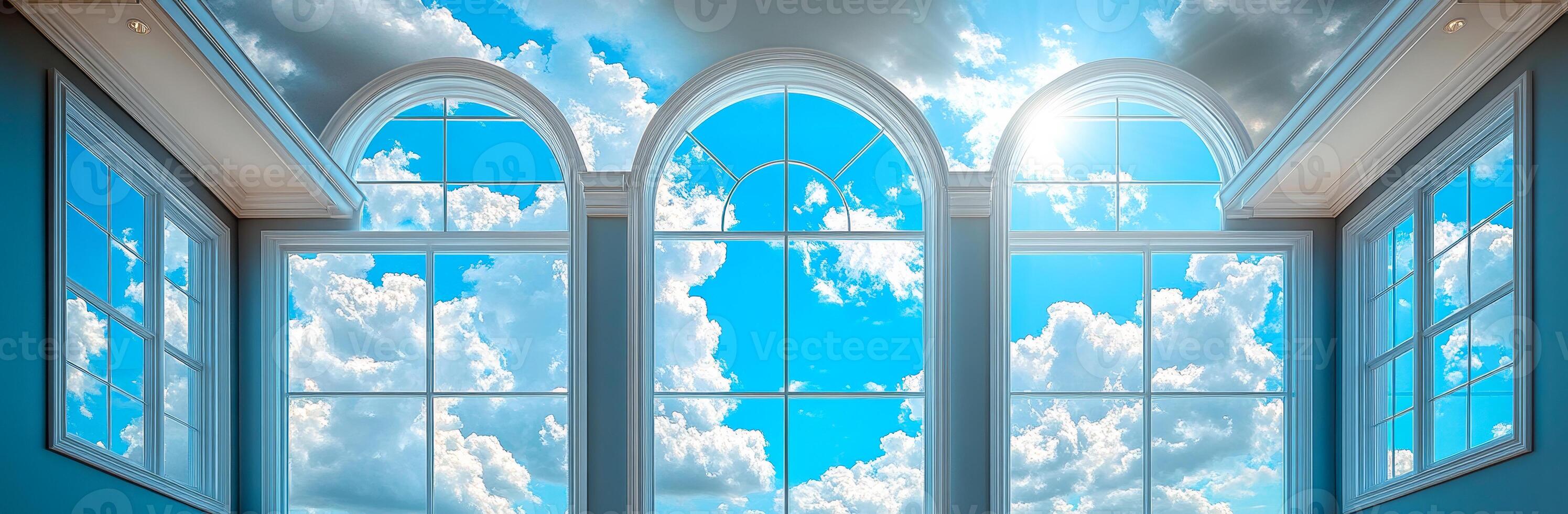 A room with three windows and a blue sky. The windows are arched and the sky is clear photo