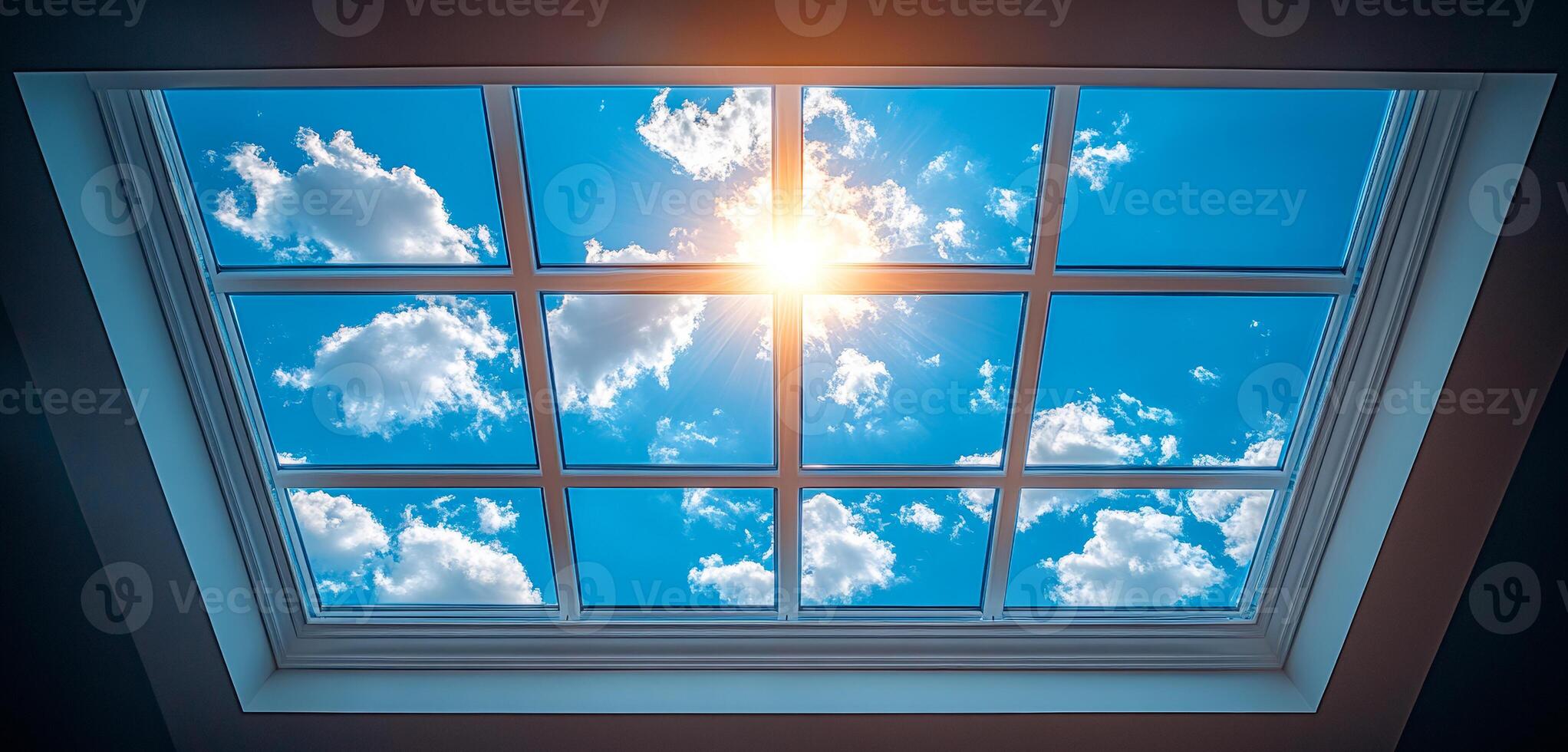 A window with a clear blue sky and clouds. The sun is shining through the window, creating a warm and inviting atmosphere photo