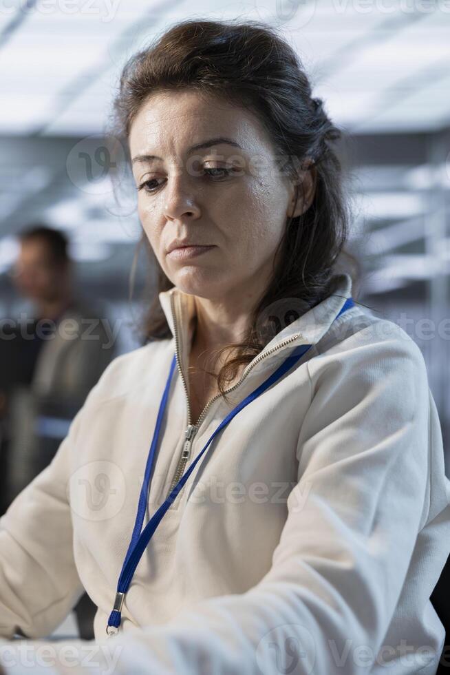 Data center system administrator developing disaster recovery plans ensuring minimal downtime. Server farm specialist uses data analytics to monitor performance and predict future infrastructure needs photo