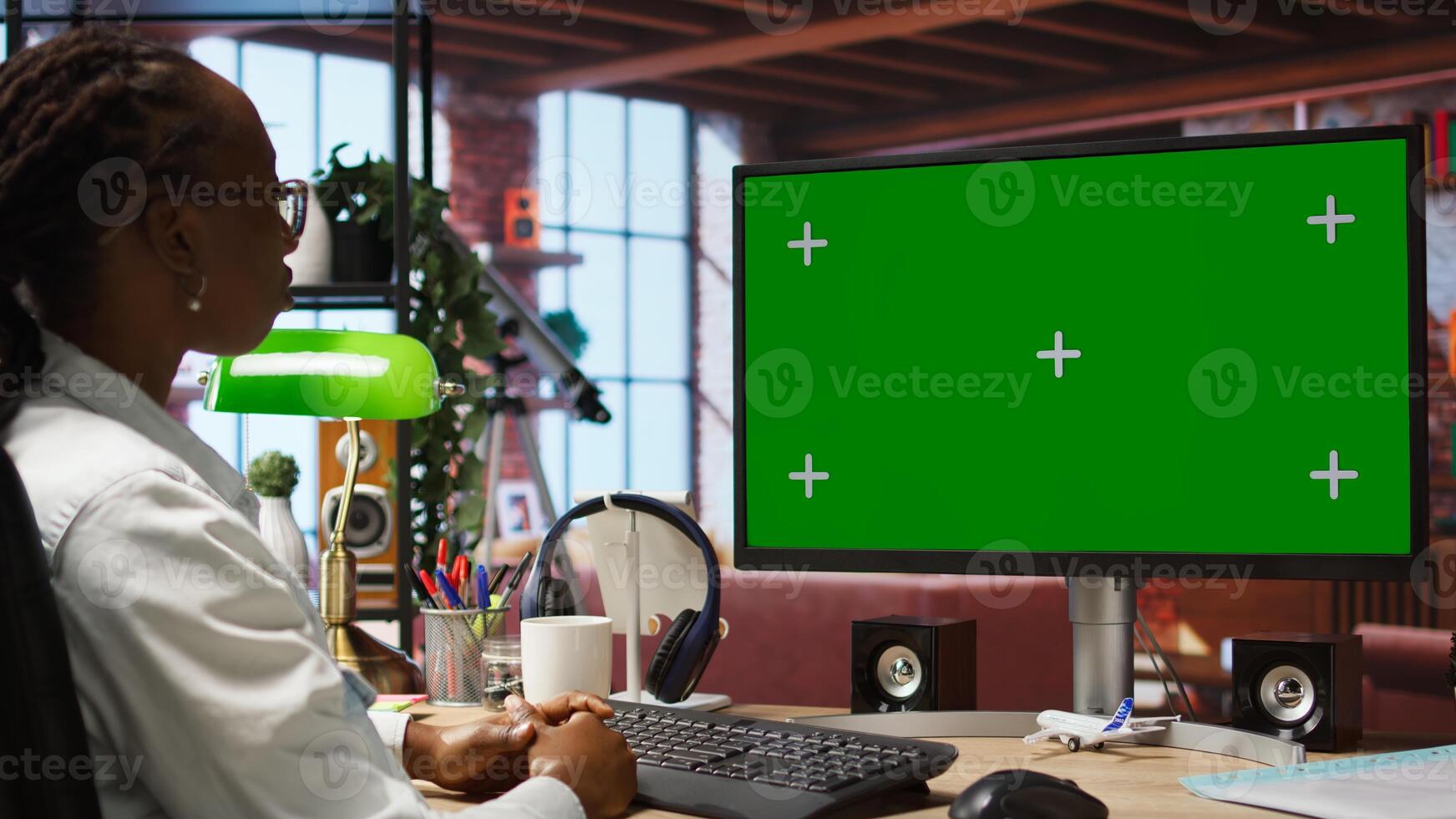 Woman enjoying leisure time at home, using green screen computer to text friends. Person talking with mates on social network online website, using mockup PC monitor, camera A photo