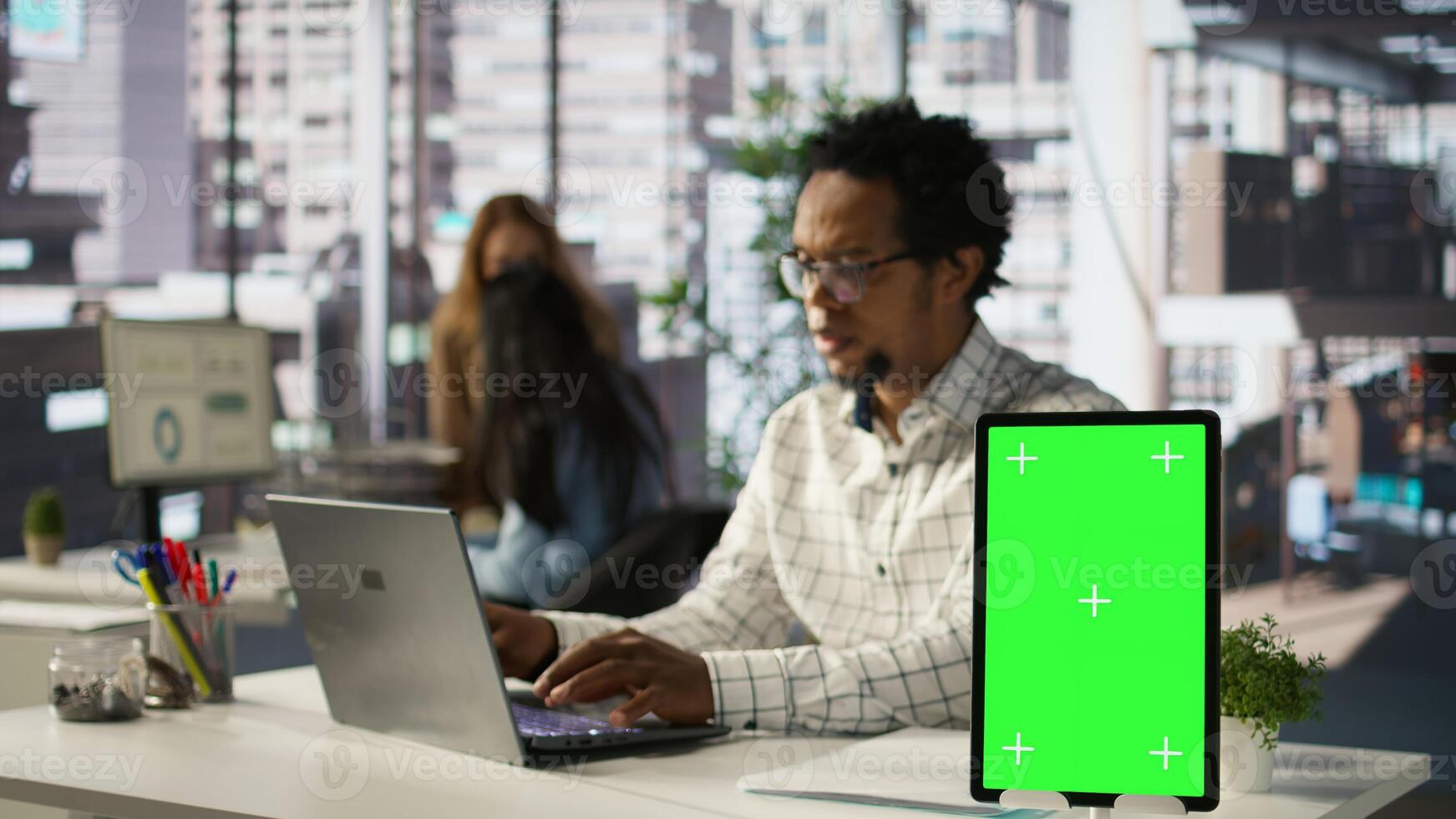 Financial consultant manages administrative tasks next to isolated copy space at his desk, focuses on business strategy. Specialist uses technology to exceed performance expectations. Camera B. photo