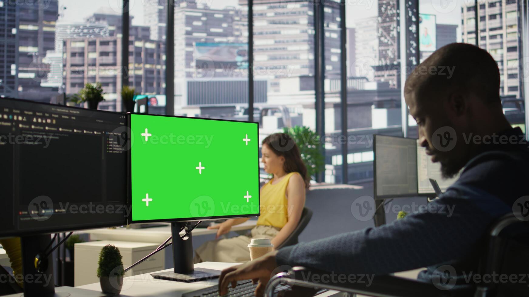 Man with disability in inclusive workplace working with machine learning tech on green screen computer. African american IT expert with paraplegia in wheelchair works with data on mockup PC, camera B photo