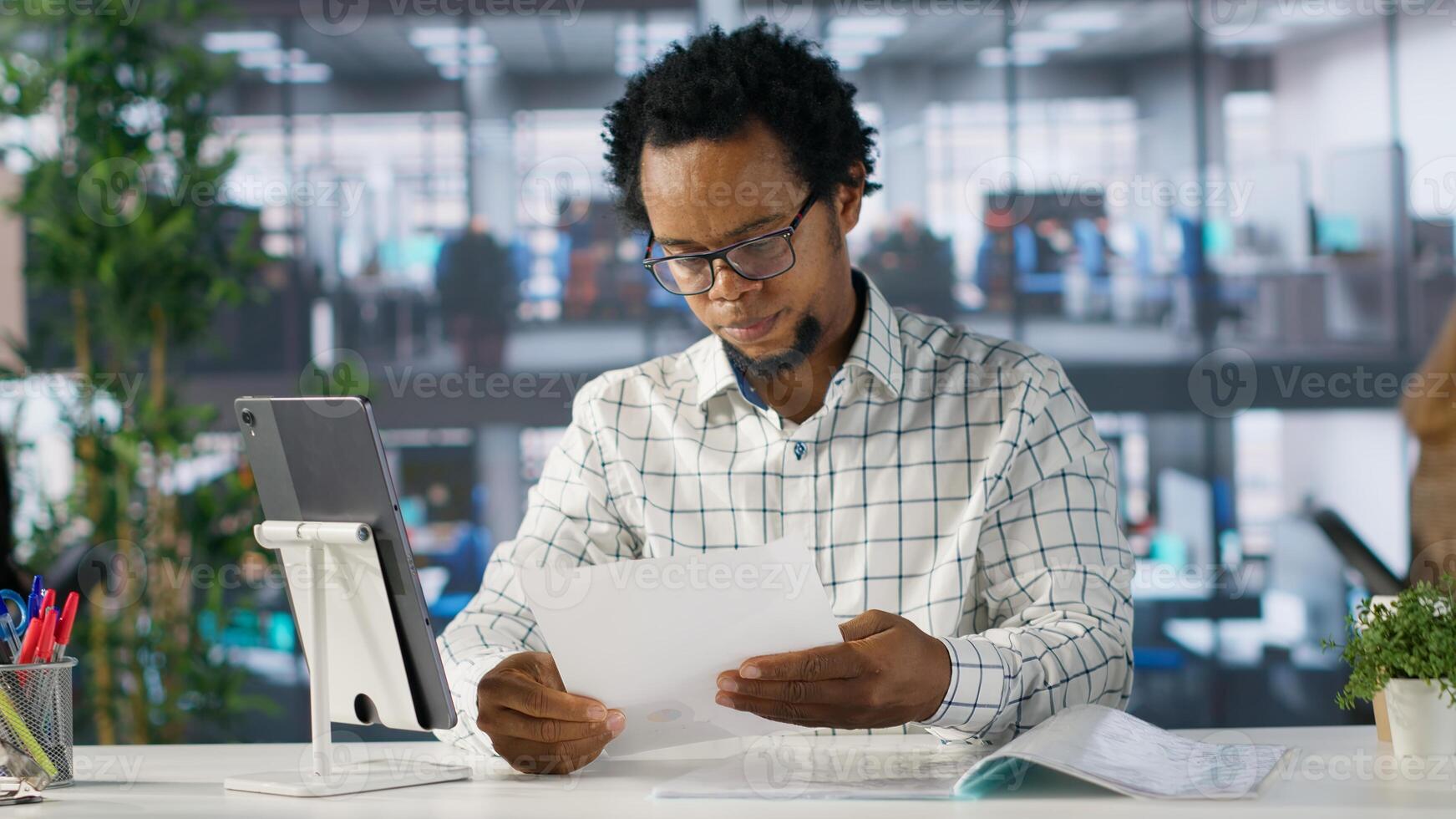 Confident businessman at his office desk working on report writing, financial planning and deadline management. Expert specialist reviewing objectives and goals to ensure success. Camera A. photo
