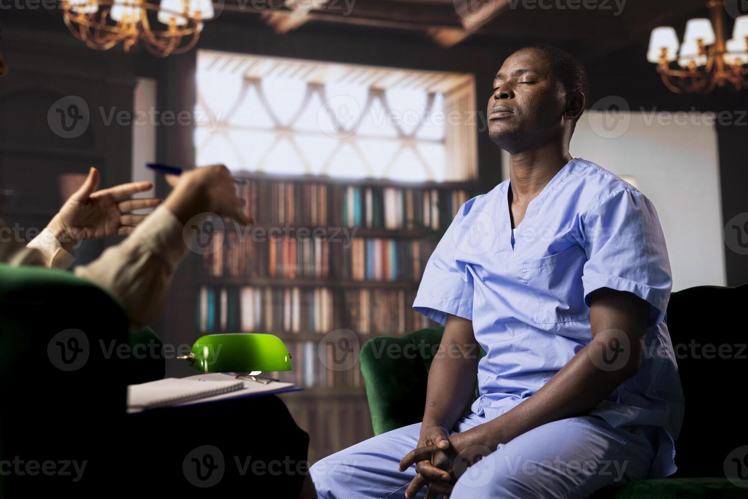 African American nurse trying to cope with stress and loss during counseling, seeking support in a therapy session. Medical assistant opening up about hard patient cases at work. photo