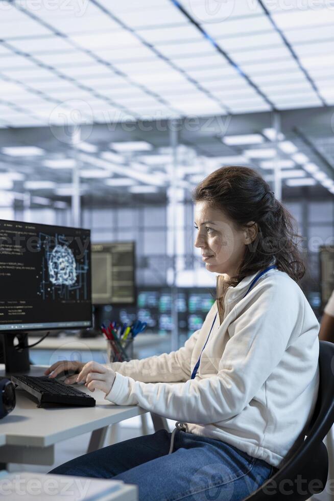 Woman trying to fix error in high tech AI data center workplace, solving tasks. Server farm artificial intelligence expert repairing bugs in mainframes, typing on computer keyboard photo