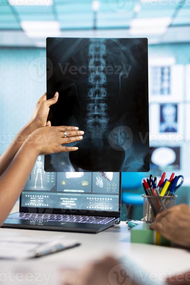 General practitioner and old patients engaging in a discussion with diagnostic reports via x ray imaging results for scan interpretation. Medical staff showcasing healthcare practices. Close up. photo