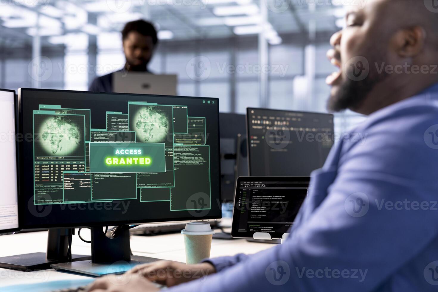 Software developer in data center getting access granted notification on PC screen, managing to access server files after they were locked by hacker using ransomware virus to blackmail company photo