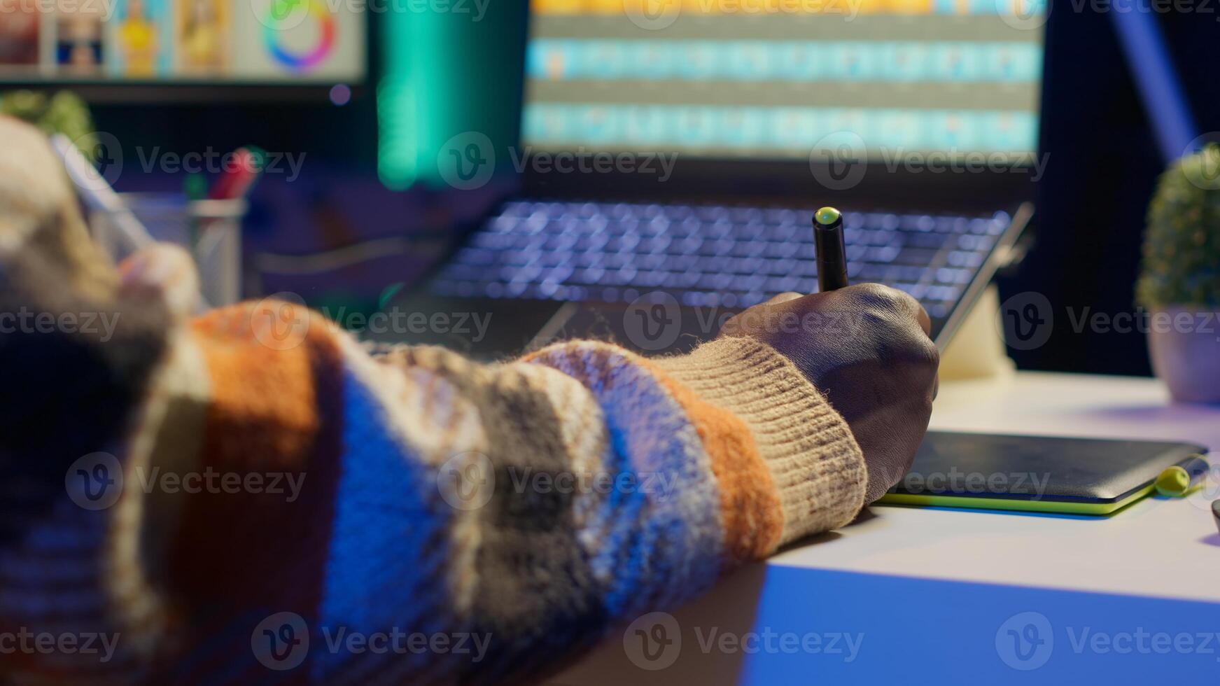Male graphic artist using essential digital tools on dual monitors, professional design work showcasing modern setup at home. Editor designer showing advanced photo editing skills. Camera A.