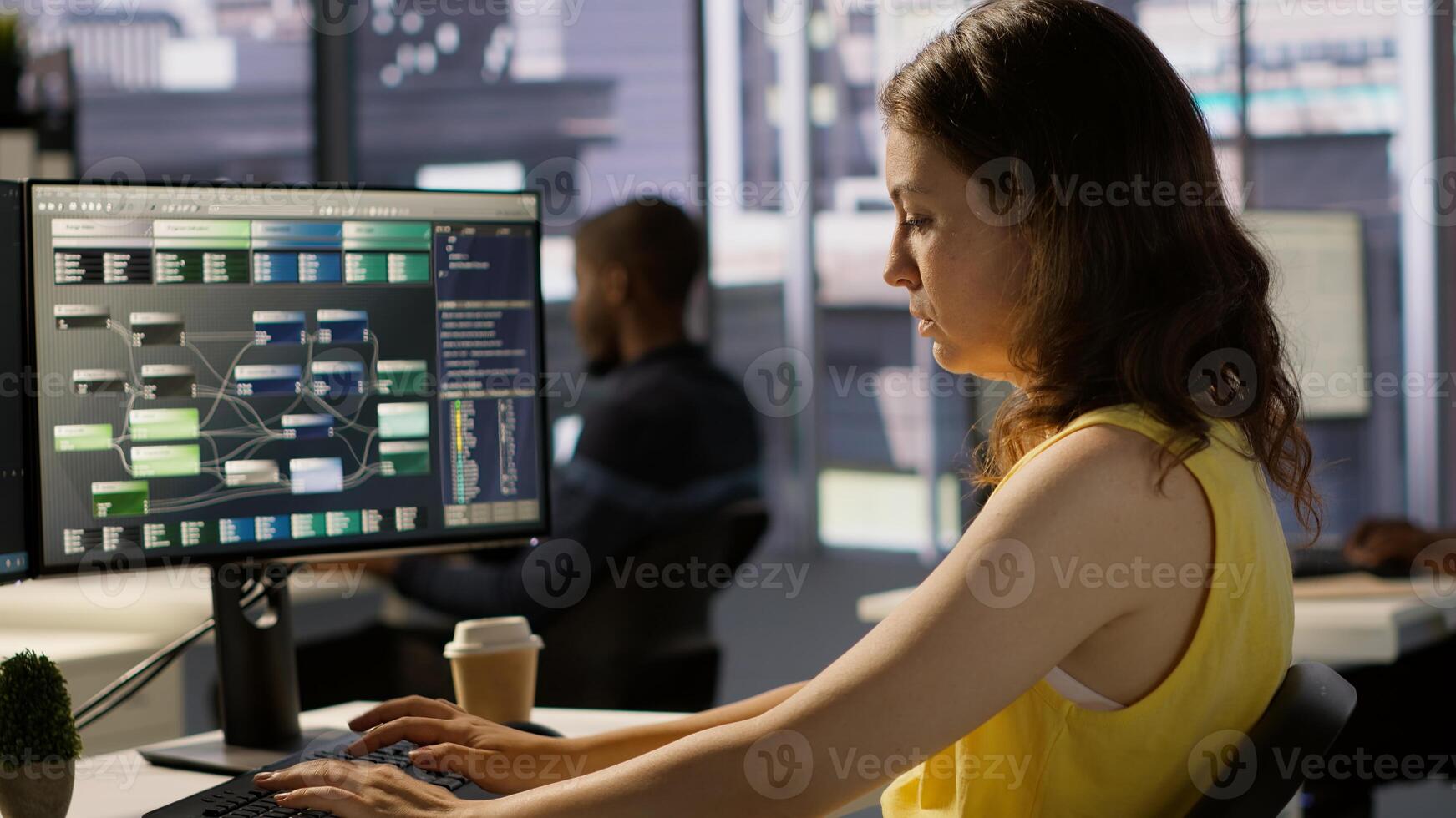 IT employee coding in programming languages to construct algorithms and build applications. Software technician developing and maintaining databases and data structures in office, camera A photo
