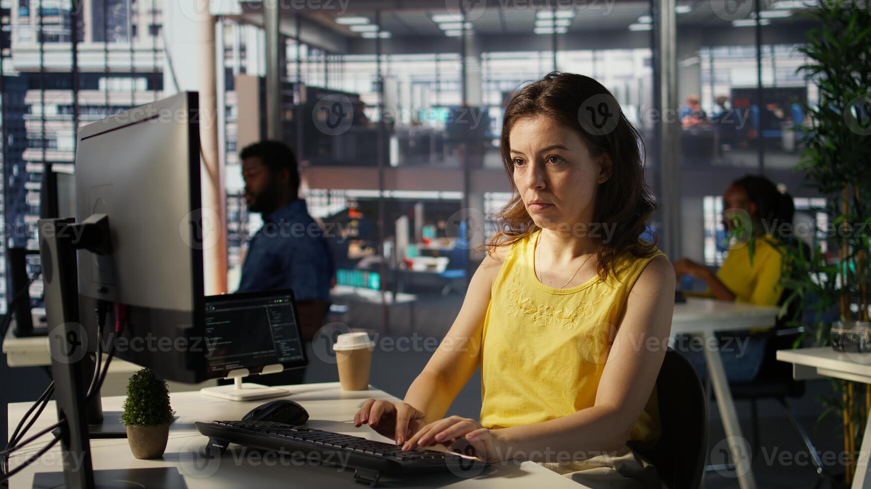 Portrait of smiling programmer creating machine learning models that can process and analyze data to automate decision making processes. Cheerful IT professional programming in office, camera B photo
