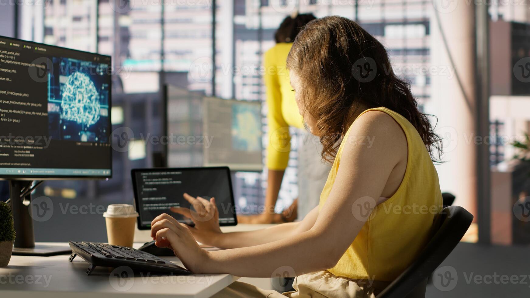 Admin tests on computer and tablet to optimize artificial intelligence machine learning models for performance and accuracy. IT worker in office analyzing and interpreting complex AI data, camera A photo