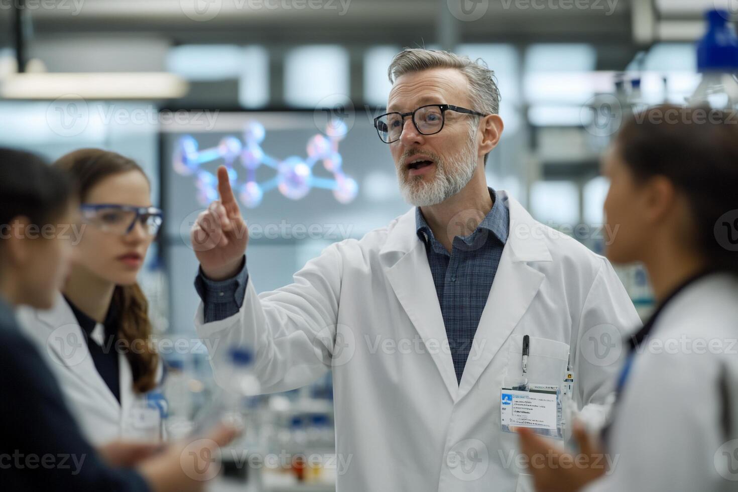 A scientist instructs a group in a laboratory setting. photo