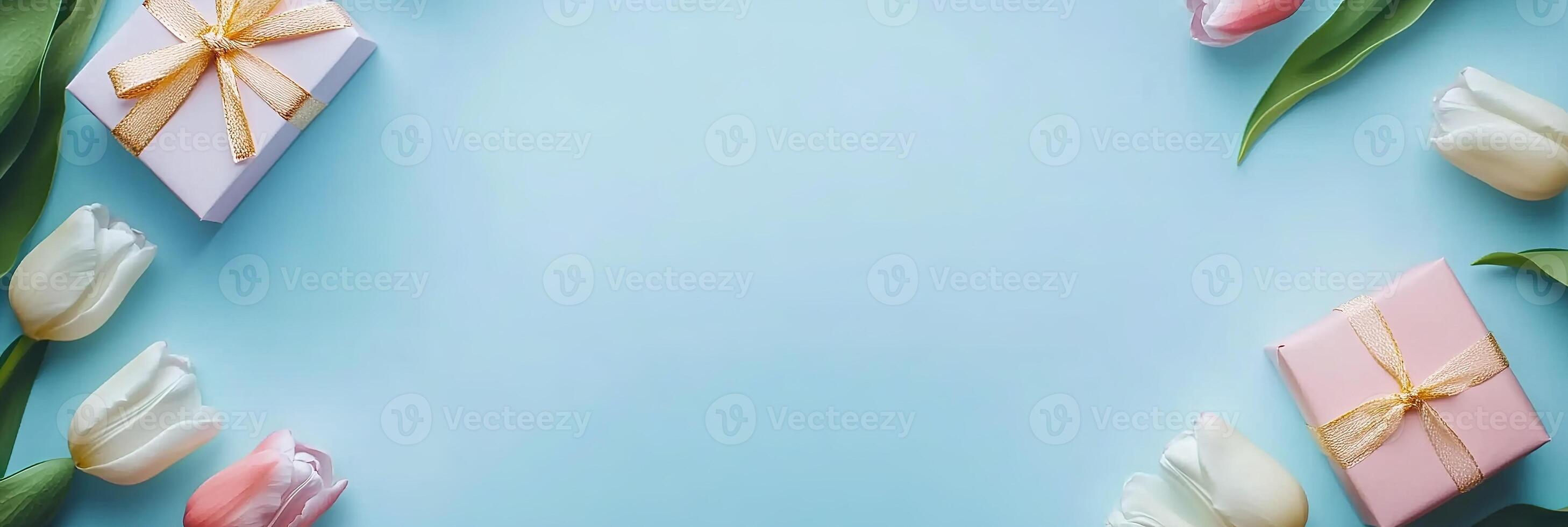 banner delicate tulips flowers border frame with small gift boxes on pastel blue background top view, beautiful floral template with copy space photo