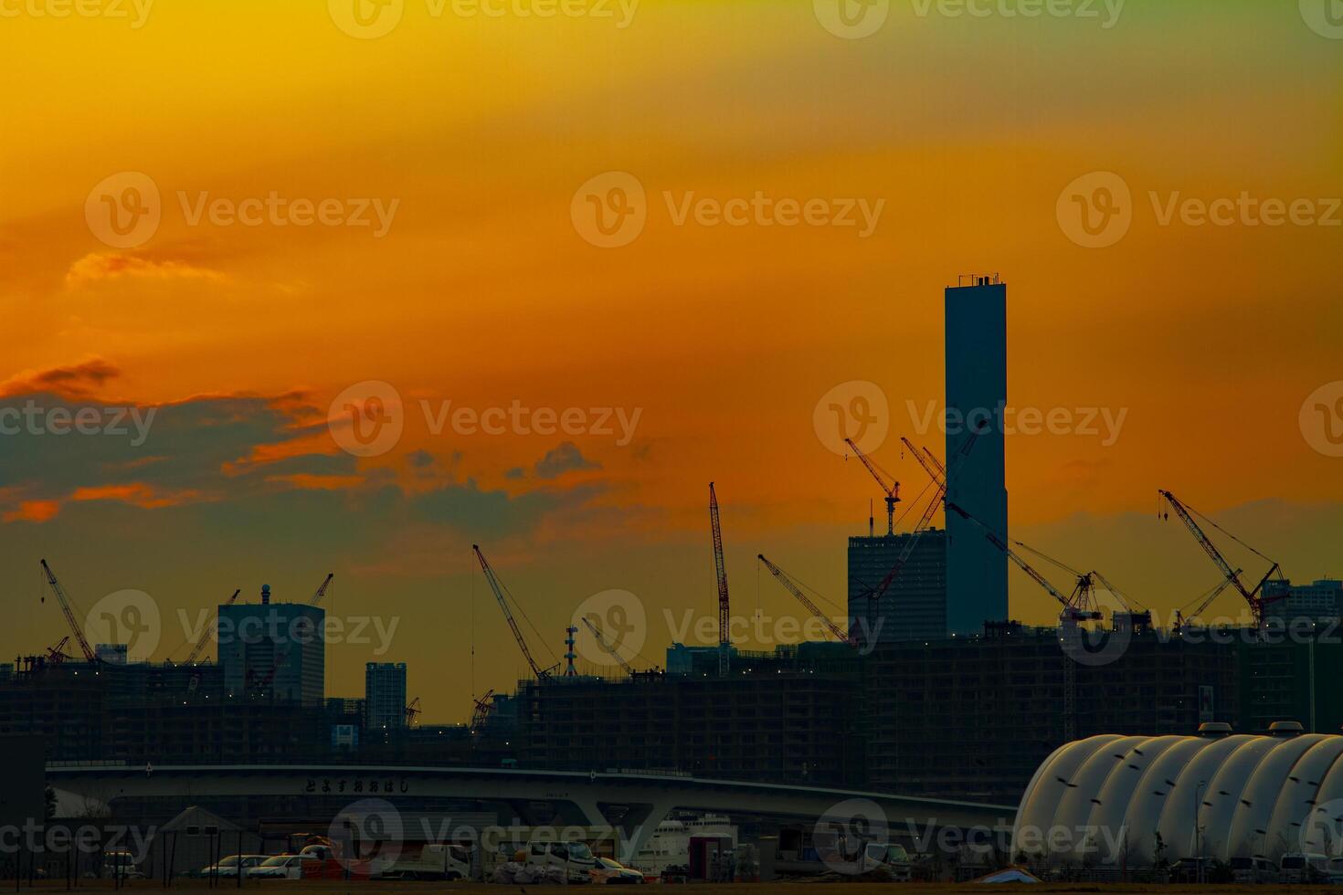 Cranes at the under construction in Tokyo at dusk photo