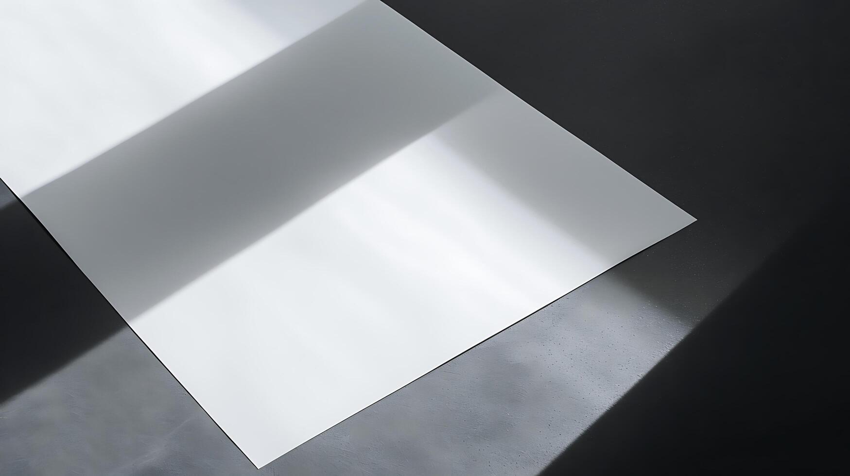 Abstract minimalistic composition of light and shadow on a blank sheet of paper set against a dark surface, creating a serene and peaceful atmosphere in photography photo