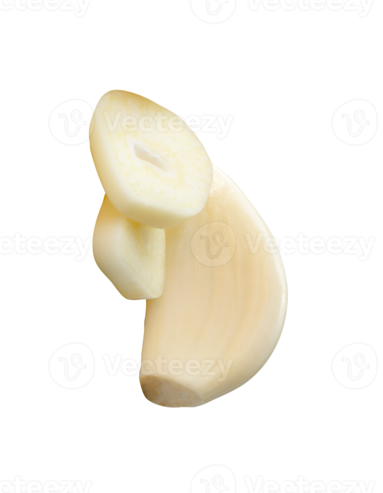 White peeled garlic cloves with slices in small heap isolated with clipping path in file format png