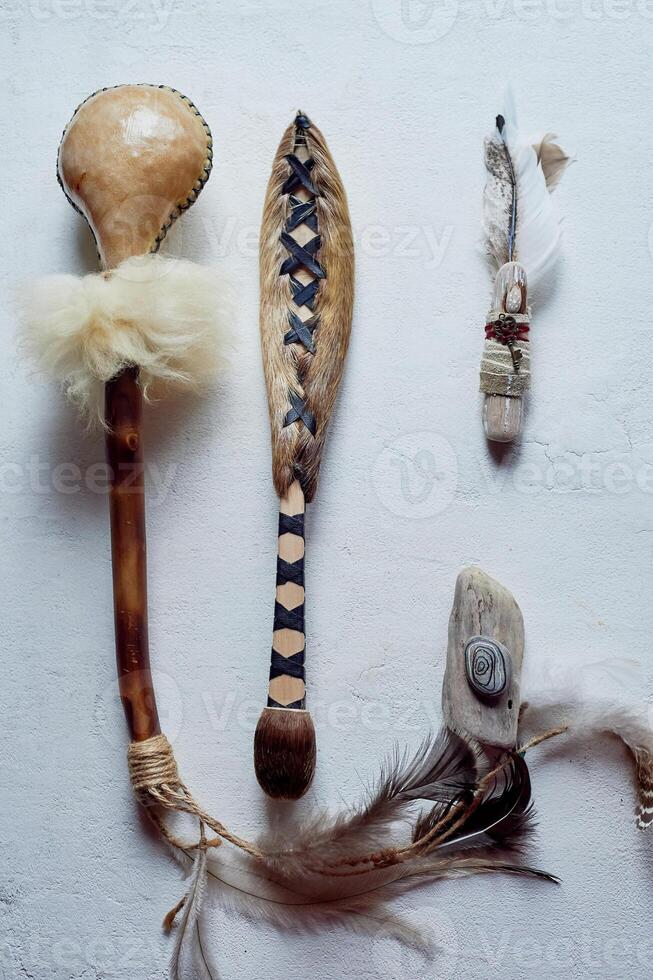 Shamanic objects. Tambourine beaters, a speaker's stick, noise makers. Ethnic Items photo