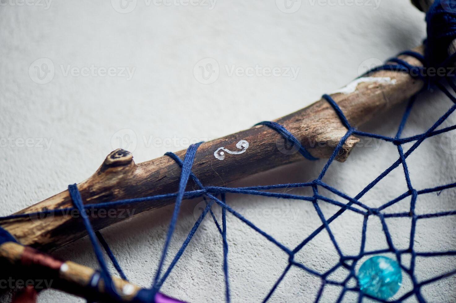 Elements of a dream catcher, beads, ribbons, wood, weaving from threads. An amulet for a restful sleep. Legends and myths. photo