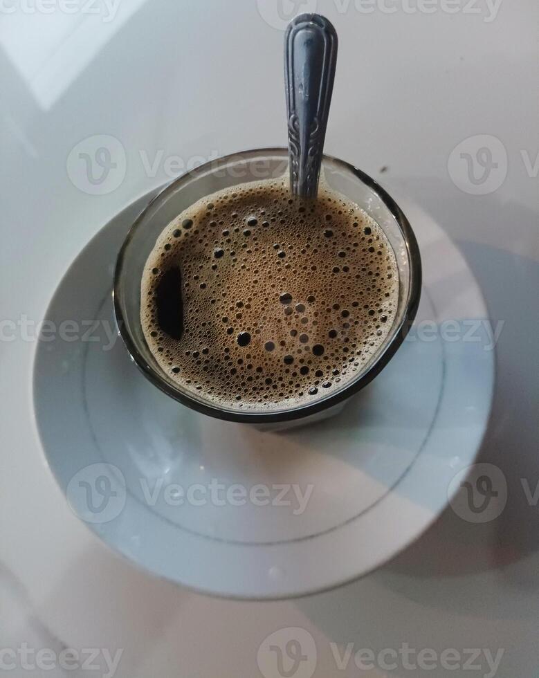 coffee drink in the middle glass on white background. Suitable for use when photographing people drinking coffee photo