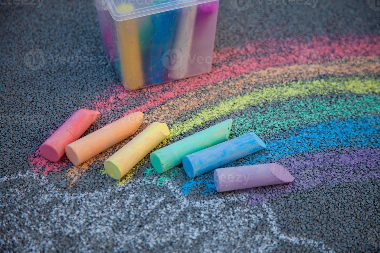 Chalks in rainbow colors. Chalk for drawing on the school board and on the street on the pavement. Children's toy is entertainment. Baby crayons. photo