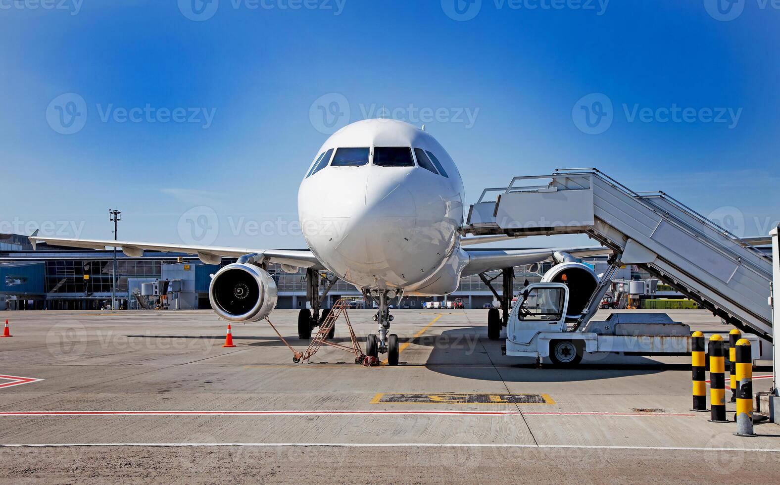 Boarding passengers on the plane. Boarding bridge. The plane lands at the international airport. Loading luggage. White airplane. Terminal Runway. Copy space photo