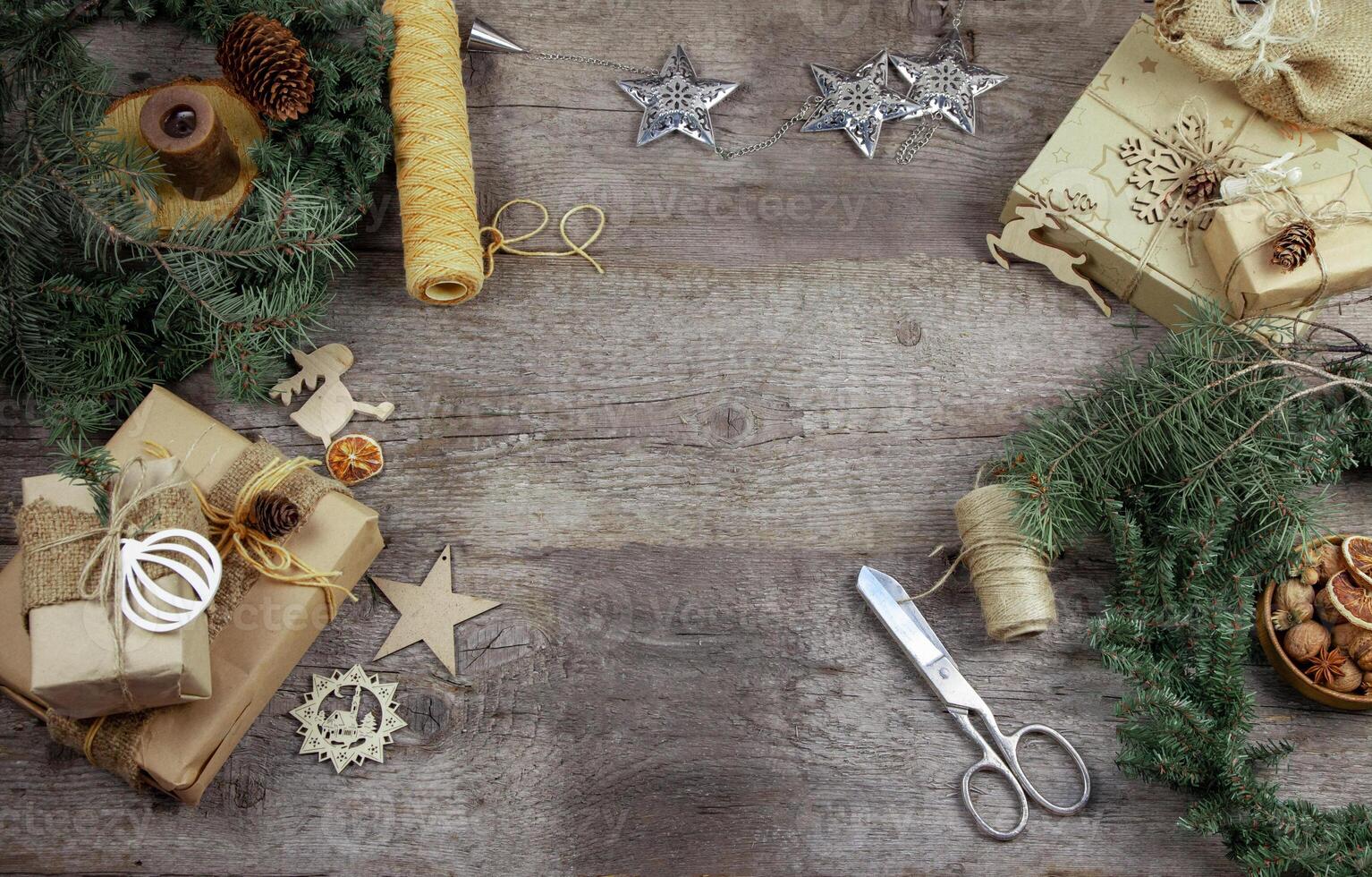 Gift wrapping for Christmas and New Year. Wooden background with place for text. Gift in craft wrapping paper. Prepare for the holiday. Copy space. photo