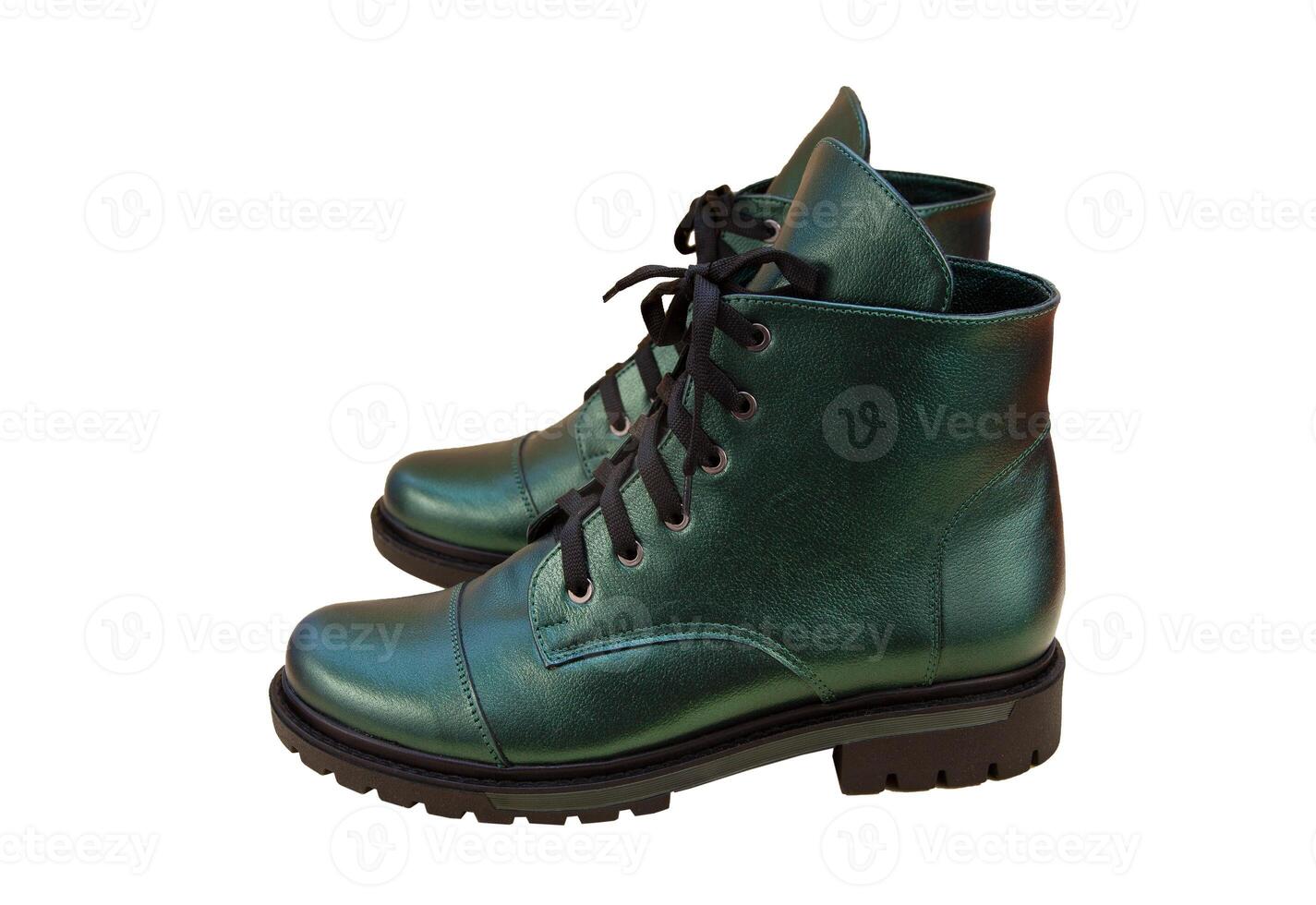 Green leather shoes isolated on white background. Winter and spring off-season boots. Stylish boot. Close-up. Laces, tractor sole. Casual style. Pearlescent fashionable color photo
