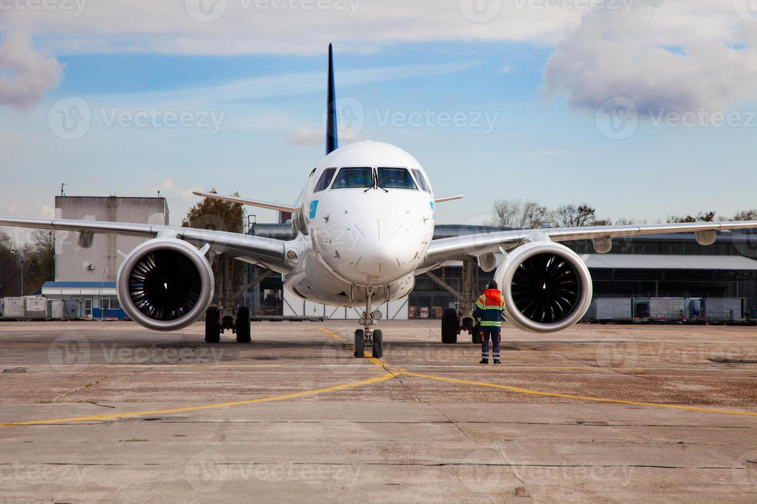 Passenger plane at the airport background. The plane lands at the international airport. White airplane. Terminal Runway. photo