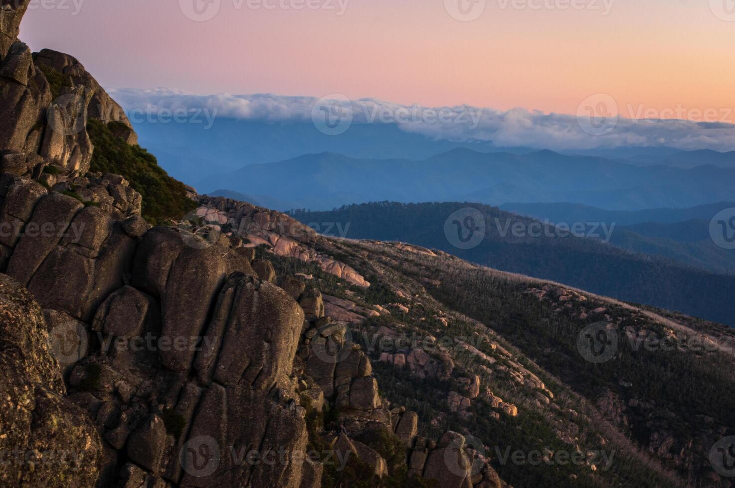 Granite mountain peak with sun setting in the background photo