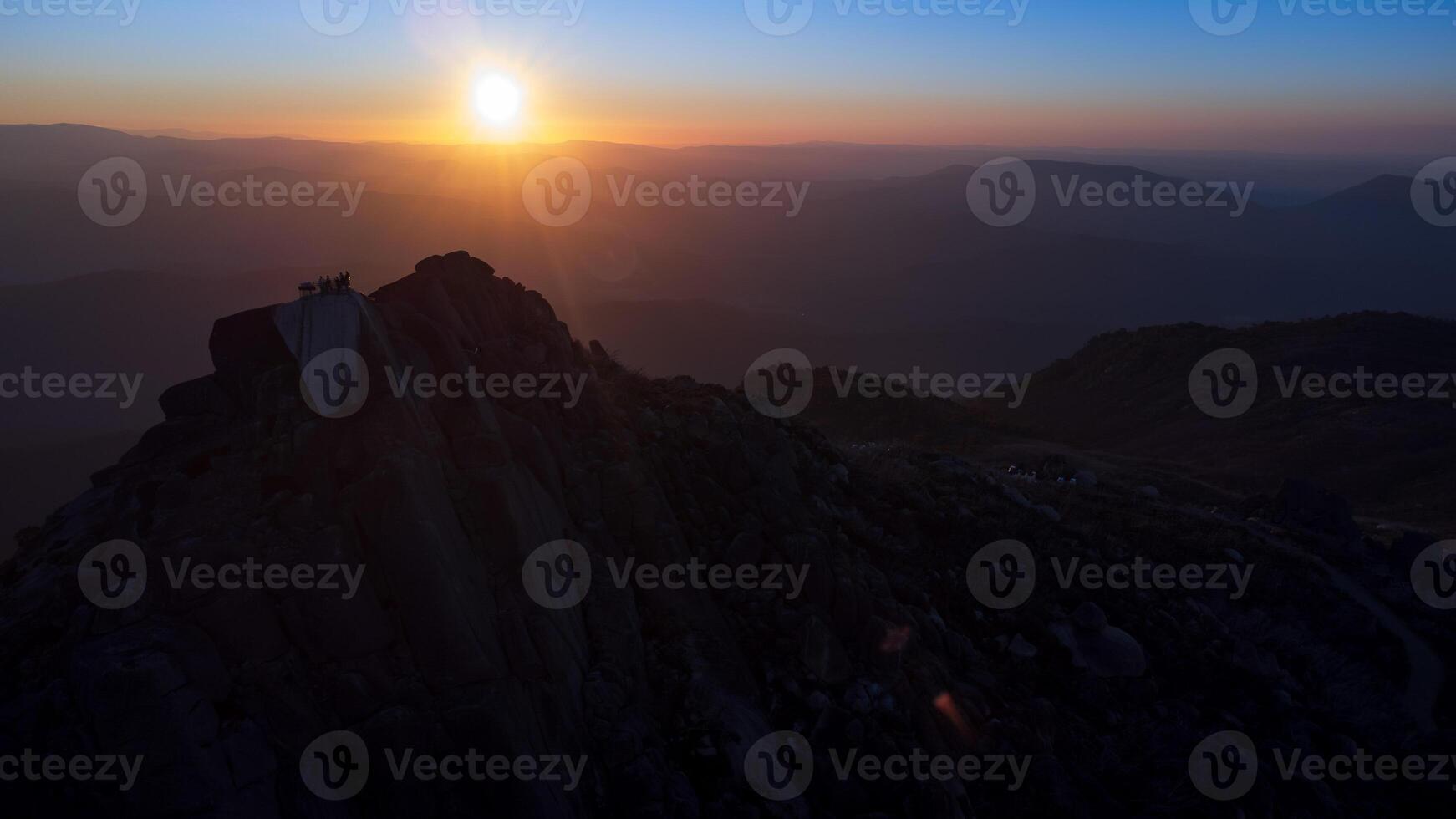 Golden hour sky with shadow mountain ranges photo