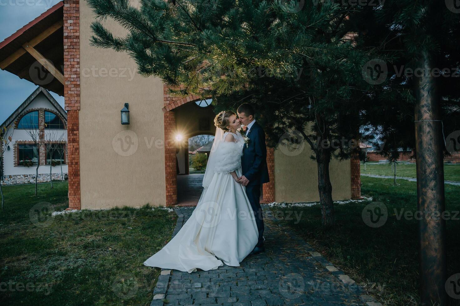 bride and groom are standing in front of a building photo