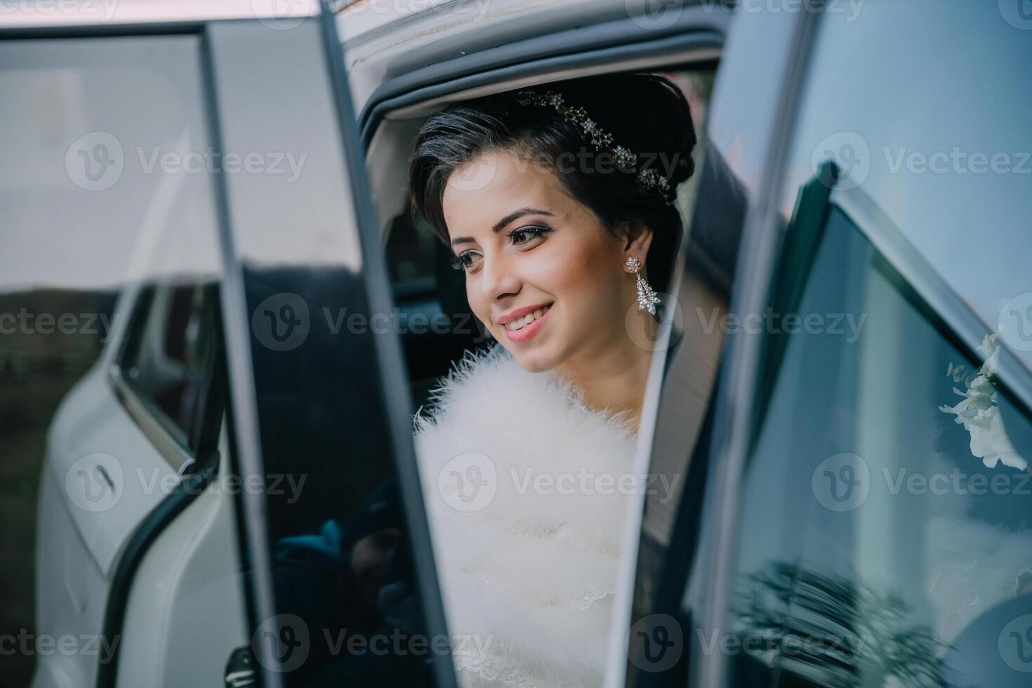 A woman in a fur coat is getting into a car photo