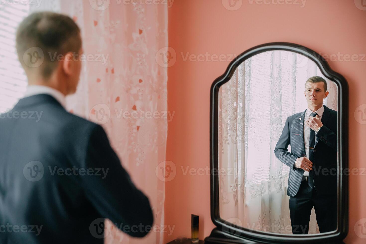 A man in a suit is getting ready for a formal event. photo