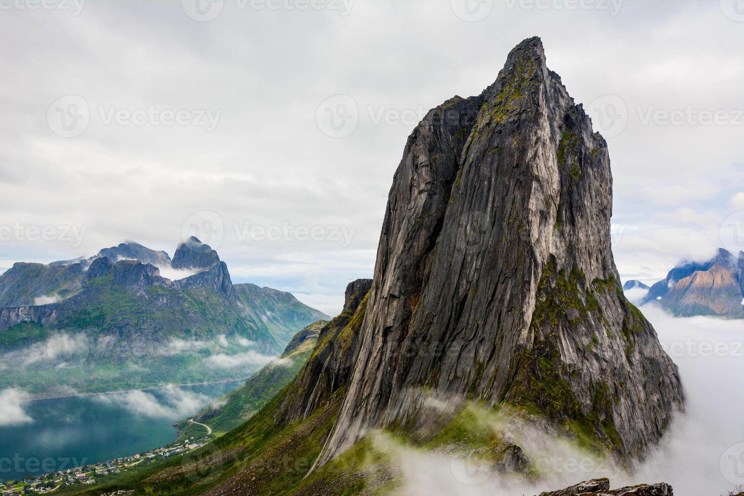 View from Mount Hesten on Iconic Mountain Segla in light of epic sunsetcovered in fog. High quality photo.Copy space. photo