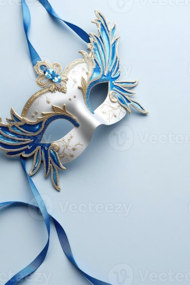 Elegant blue and gold masquerade mask on light background. photo