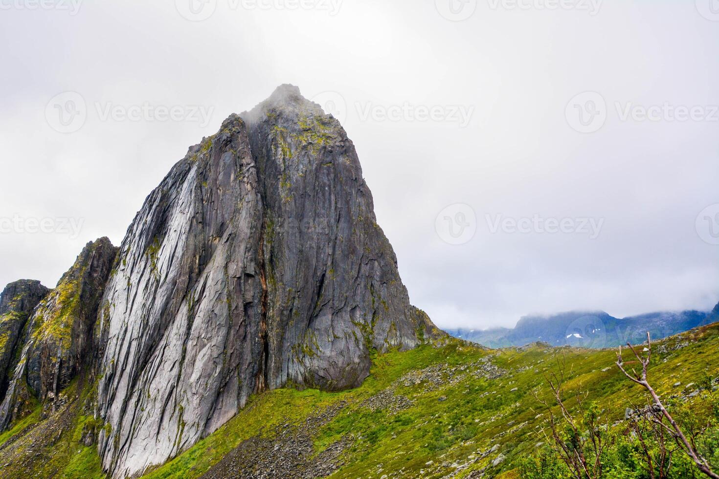 View from Mount Hesten on Iconic Mountain Segla in light of epic sunsetcovered in fog. High quality photo.Copy space. photo