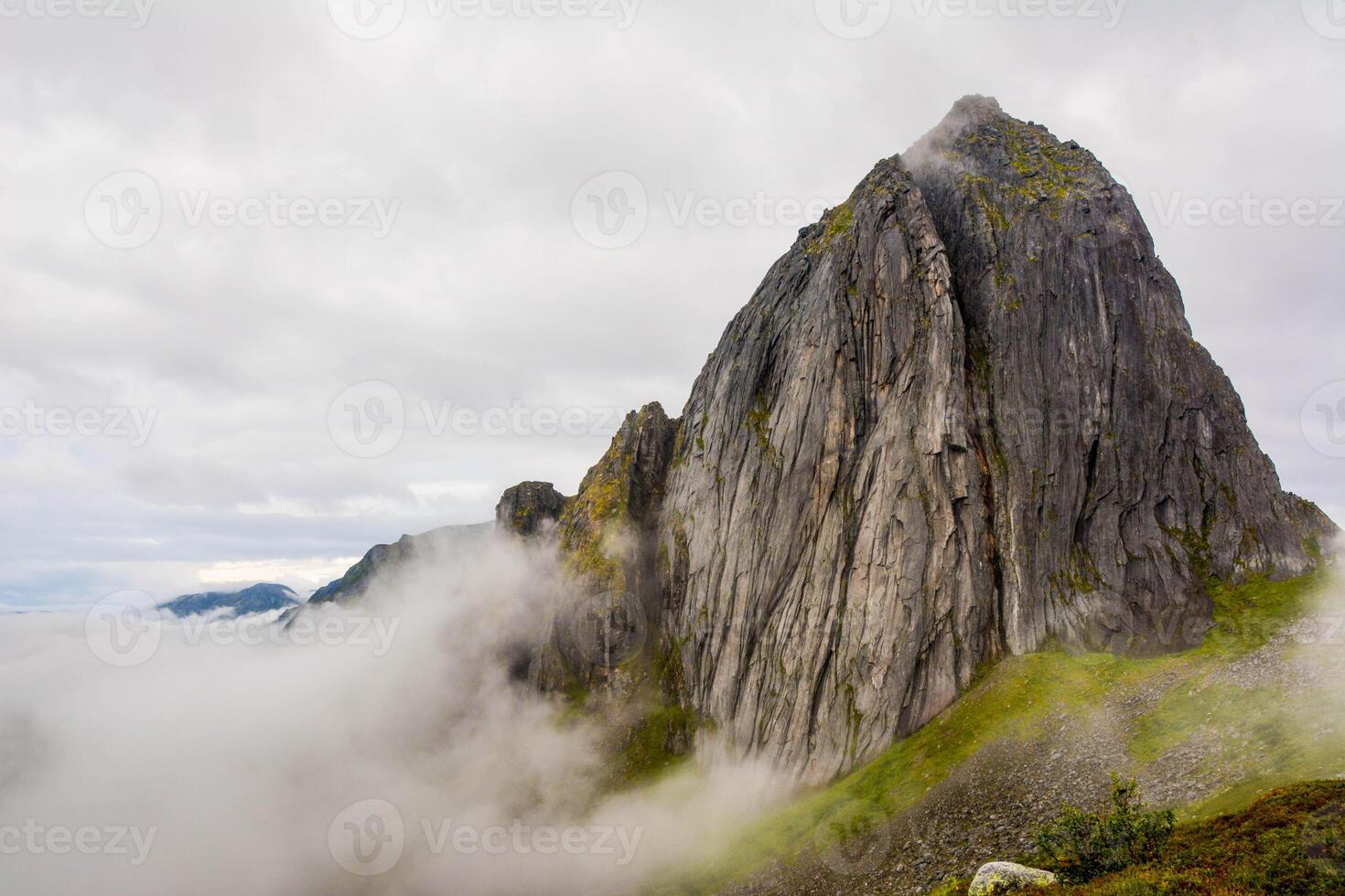 View from Mount Hesten on Iconic Mountain Segla in light of epic sunsetcovered in fog. High quality photo.Copy space. photo
