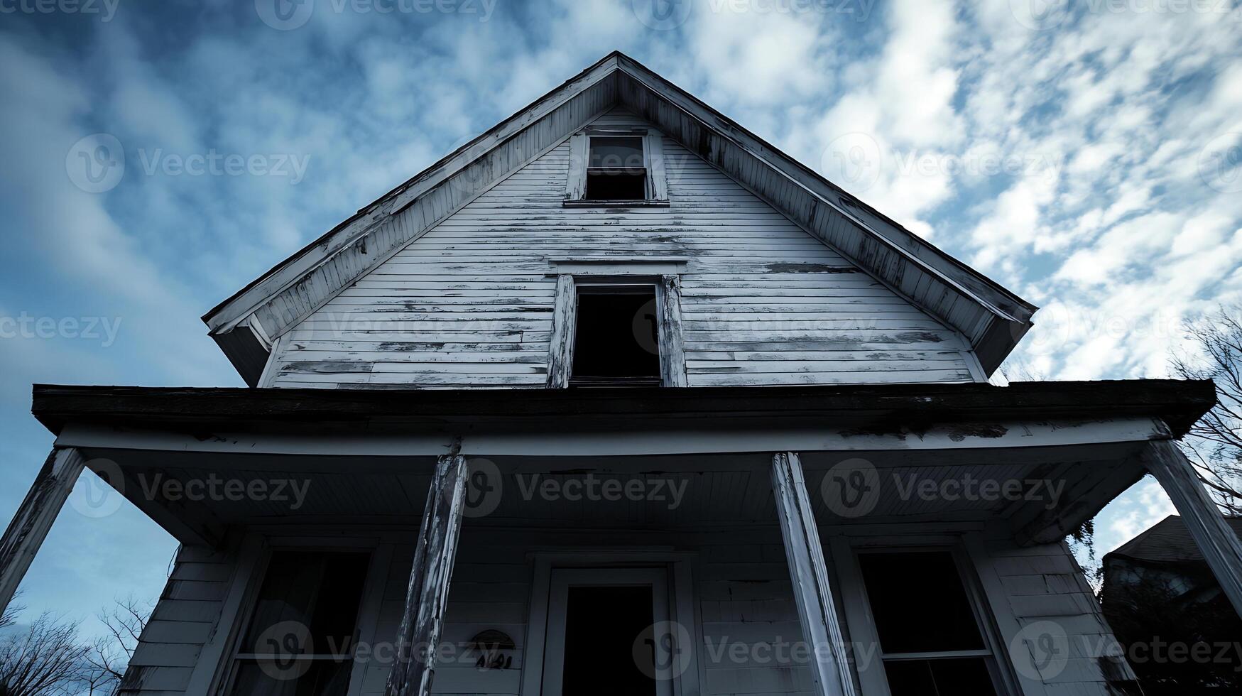 Abandoned Rustic House with Weathered Wooden Facade and Cloudy Sky photo