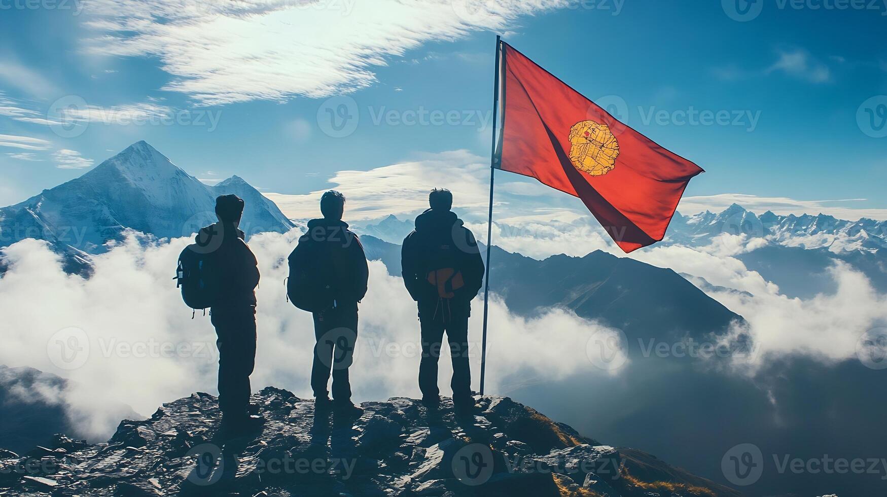 Hikers on Mountain Peak Admiring Scenic View with Red Flag and Majestic Snowy Mountains photo